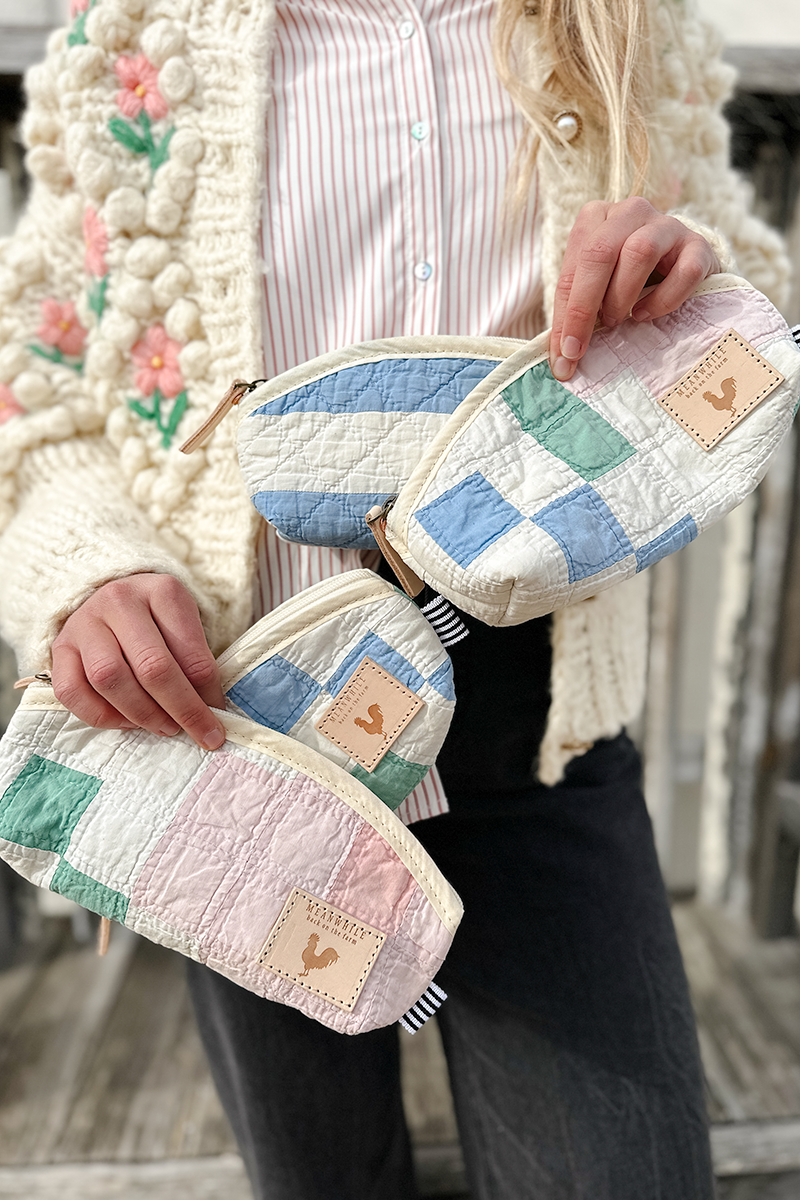 Girl holding a few of the small patched quilted makeup bags