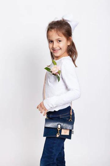Little Girl wearing Dark Blue Leather Crossbody Purse with tan straps