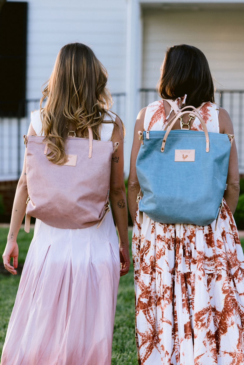Young women with blue leather bag and pink leather bag