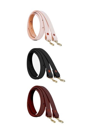 Three leather straps (black, light pink, and maroon) rolled up in coils
