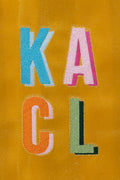 A close up of the Rover Yellow XL Canvas Snap Tote with colorful letters 'K', 'A', 'C', and 'L' 