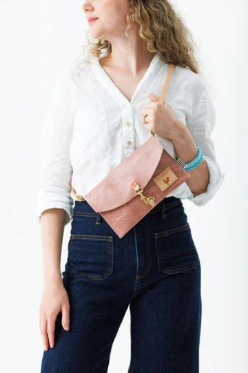 Girl wearing Rose Pink Leather Crossbody Purse with tan straps