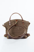 A brown waxed canvas tote bag with dark brown leather handles, straps, and hardware, displayed on a clean white background. Handmade by Meanwhile Back on the Farm in Lynchburg,VA