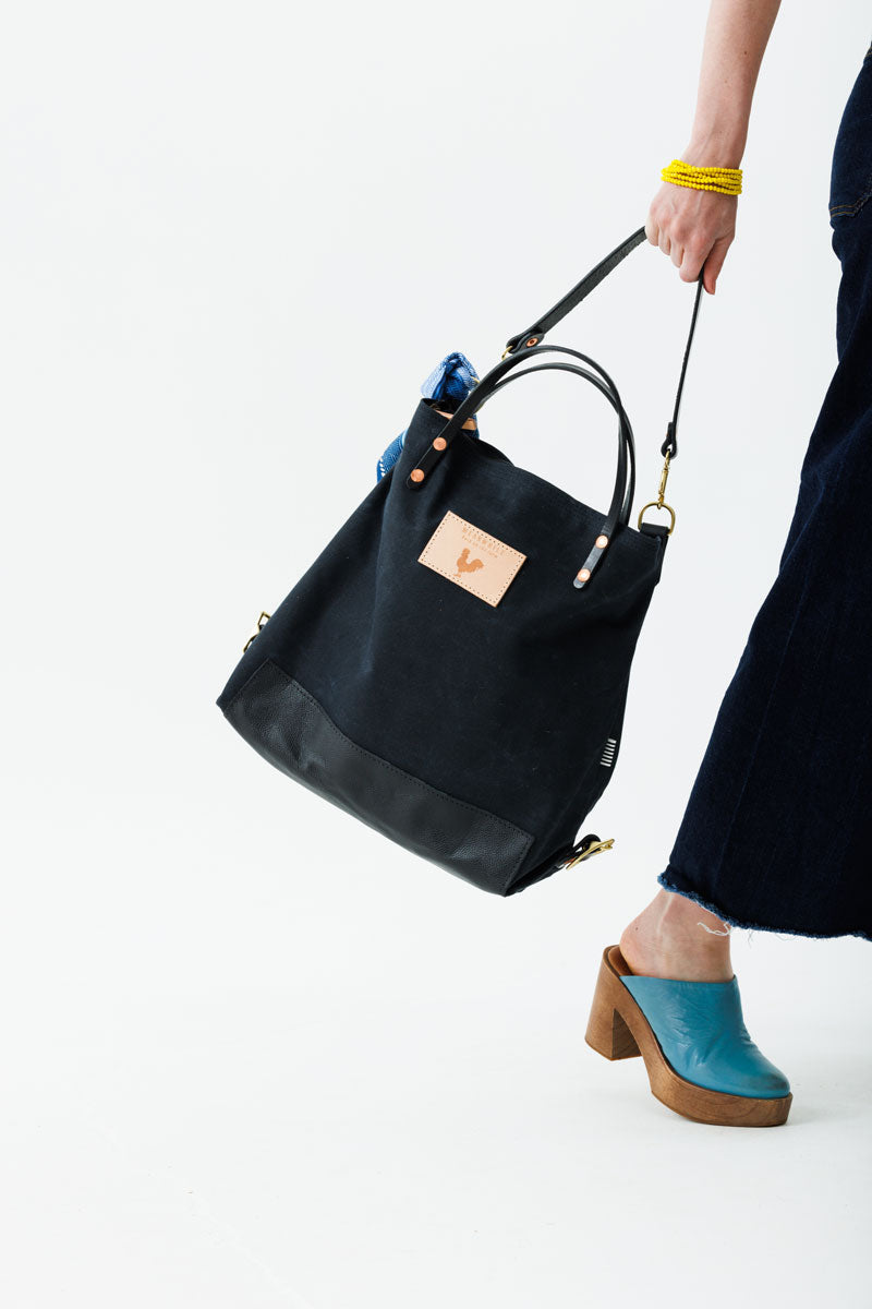 the black backpack with blue decorative scarf