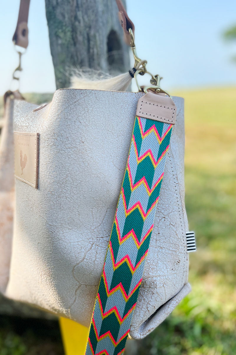 Birch white leather small tote with blue, green, and orange patterned webbing crossbody strap