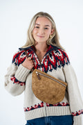 A woman wearing a cream knit sweater with a red and navy Fair Isle pattern, carrying a brown embossed faux-leather crossbody bag across her torso, set against a plain white studio background. Handmade by Meanwhile Back on the Farm in Lynchburg,VA