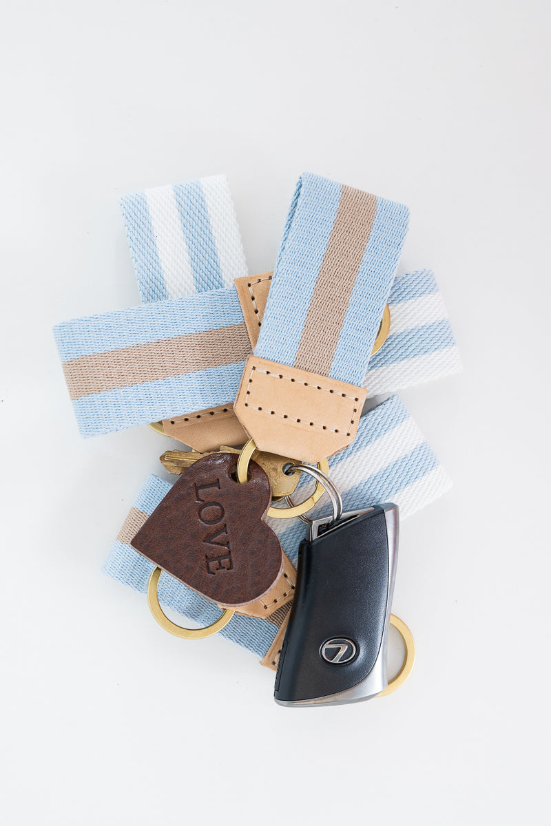 Multiple keychains with striped key fobs and heart charm