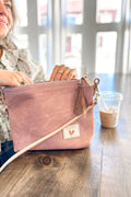 Girl opening the Rose Leather Sling Bag