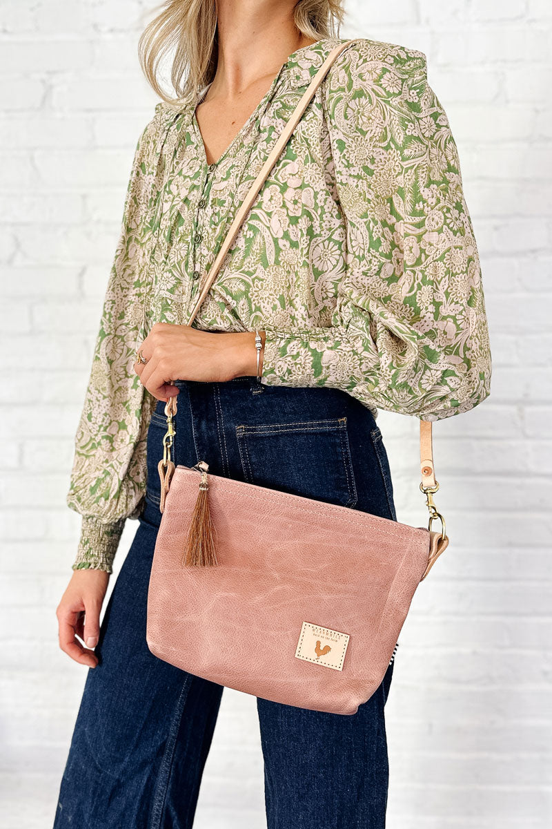 Girl holding the Rose Leather Sling Bag