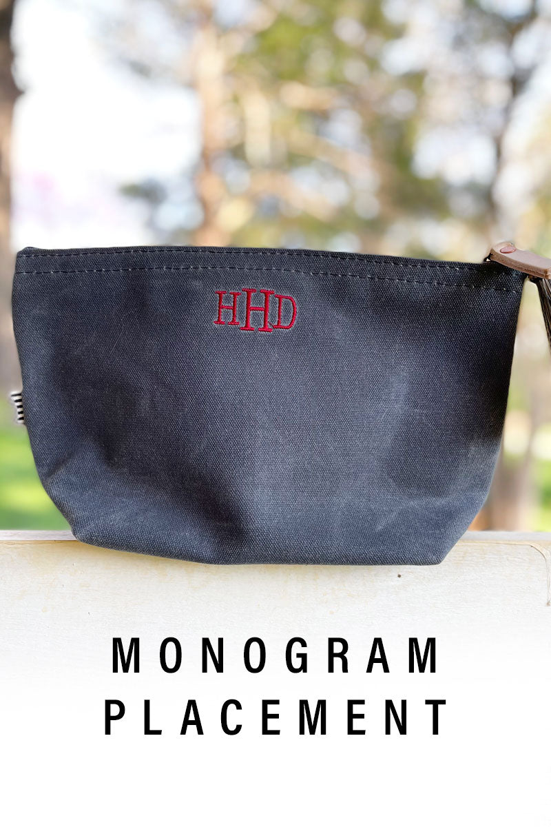 An image showing a black leather bag with a personalized monogram with the text "monogram placement"
