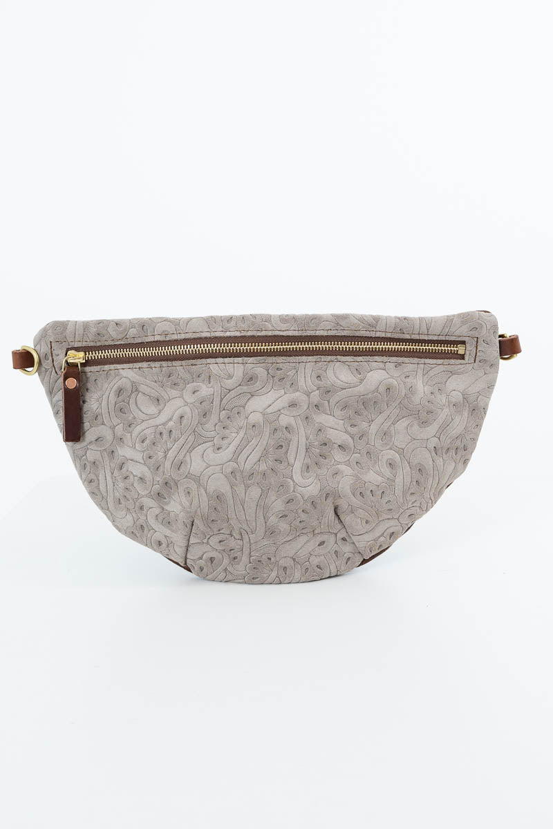 A light gray leather fanny pack with an embossed paisley pattern and a brown zipper, shown against a plain white background. Handcrafted by Meanwhile Back on the Farm in Lynchburg, Va.