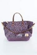 A purple snakeskin-patterned tote bag with brown leather handles and a matching shoulder strap, shown on a clean white background. Handcrafted by Meanwhile Back on the Farm in Lynchburg, Va.