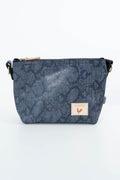 A small crossbody bag with a dark blue-gray snakeskin pattern, featuring a tan leather brand patch on the front and a black strap. Handcrafted by Meanwhile Back on the Farm in Lynchburg, Va.