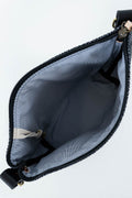 An open black zipper pouch showing a light gray fabric interior, photographed on a plain white background.