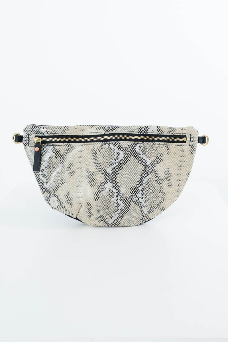 A  waist bag featuring a beige and gray snakeskin pattern, with a black zipper and small gold-tone hardware, set against a plain white background. Handcrafted by Meanwhile Back on the Farm in Lynchburg, Va.