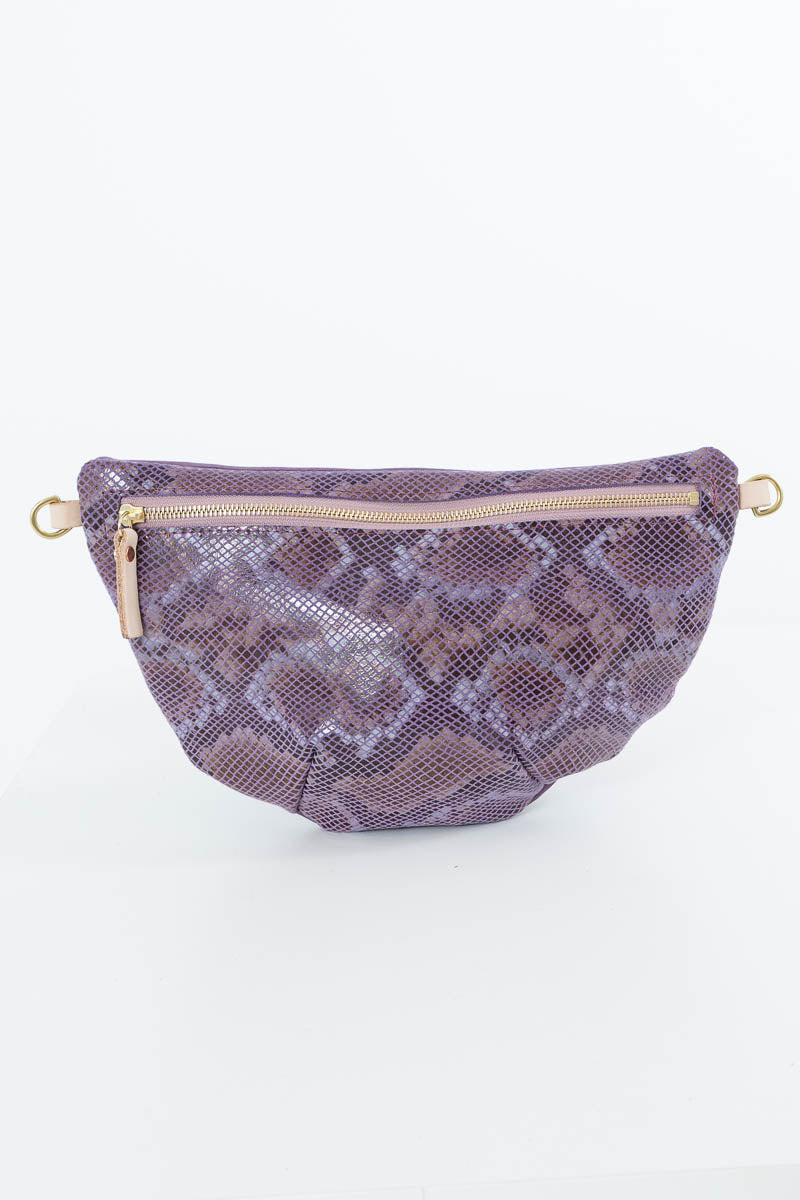 A purple snakeskin-patterned waist bag with a top zipper and gold-tone hardware, photographed against a plain white background. Handcrafted by Meanwhile Back on the Farm in Lynchburg, Va.