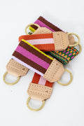 Colorful striped Meanwhile Back on the Farm webbing key fobs with leather accents