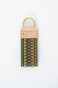 Colorful webbing key fob with shades of green, pink, orange, and gold and the Meanwhile Back on the Farm logo