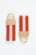 Two orange and pink striped Meanwhile Back on the Farm webbing key fobs