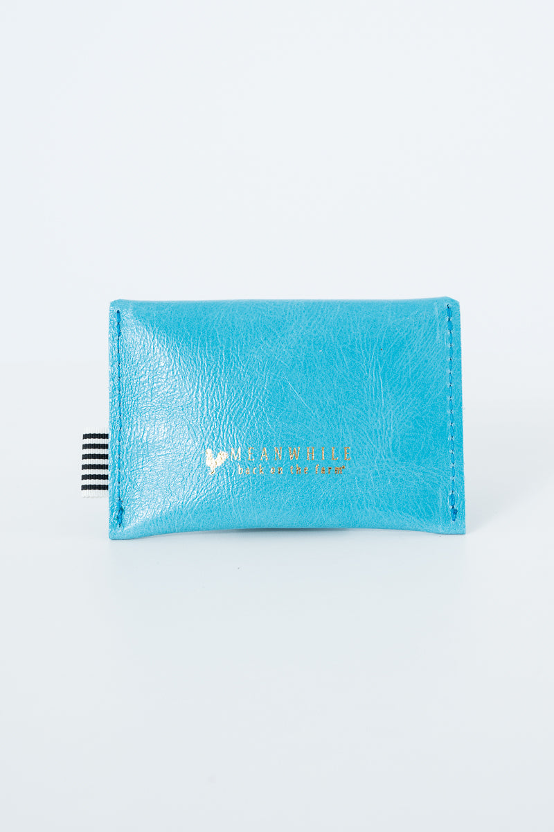 Blue snap pouch with Meanwhile brand logo