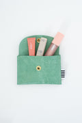 Green snap pouch with two lip balms and a lip gloss
