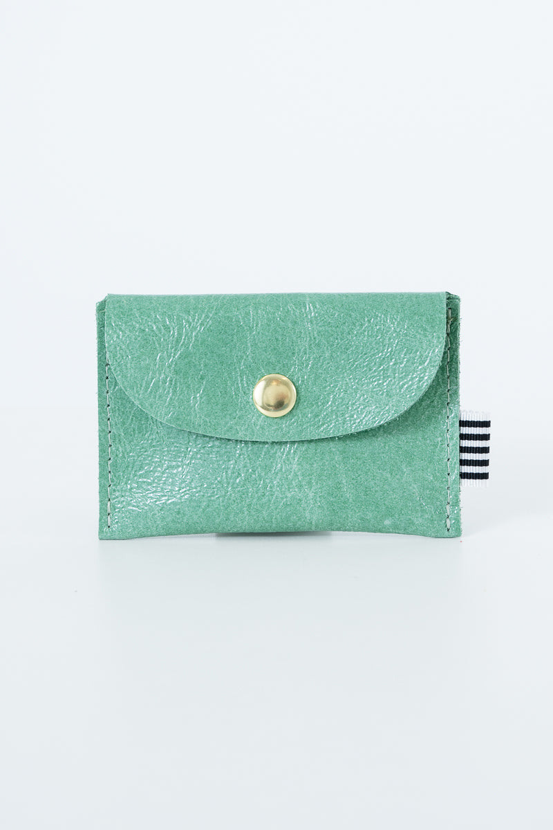 Green snap pouch with a gold snap closure
