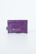 Purple snap pouch with gold Meanwhile brand logo text