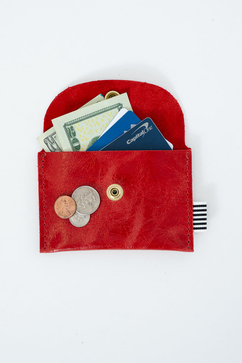 Red leather snap pouch with money, cards, and coins