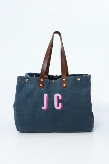 Navy Meanwhile Back on the Farm tote bag with pink initials 'JC' in the center