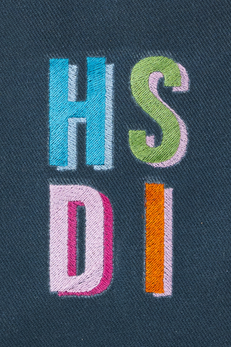 A close up view of the Slate XL Canvas Snap Tote with embroidered letters 'H', 'S', 'D', and 'I'