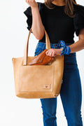 Woman holding natural Virginia leather signature tote bag
