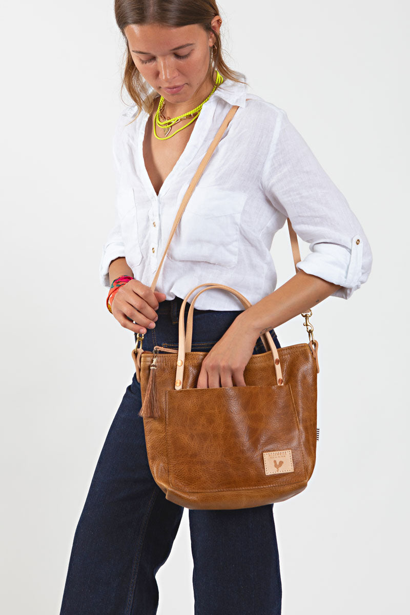 Woman holding camel leather small tote