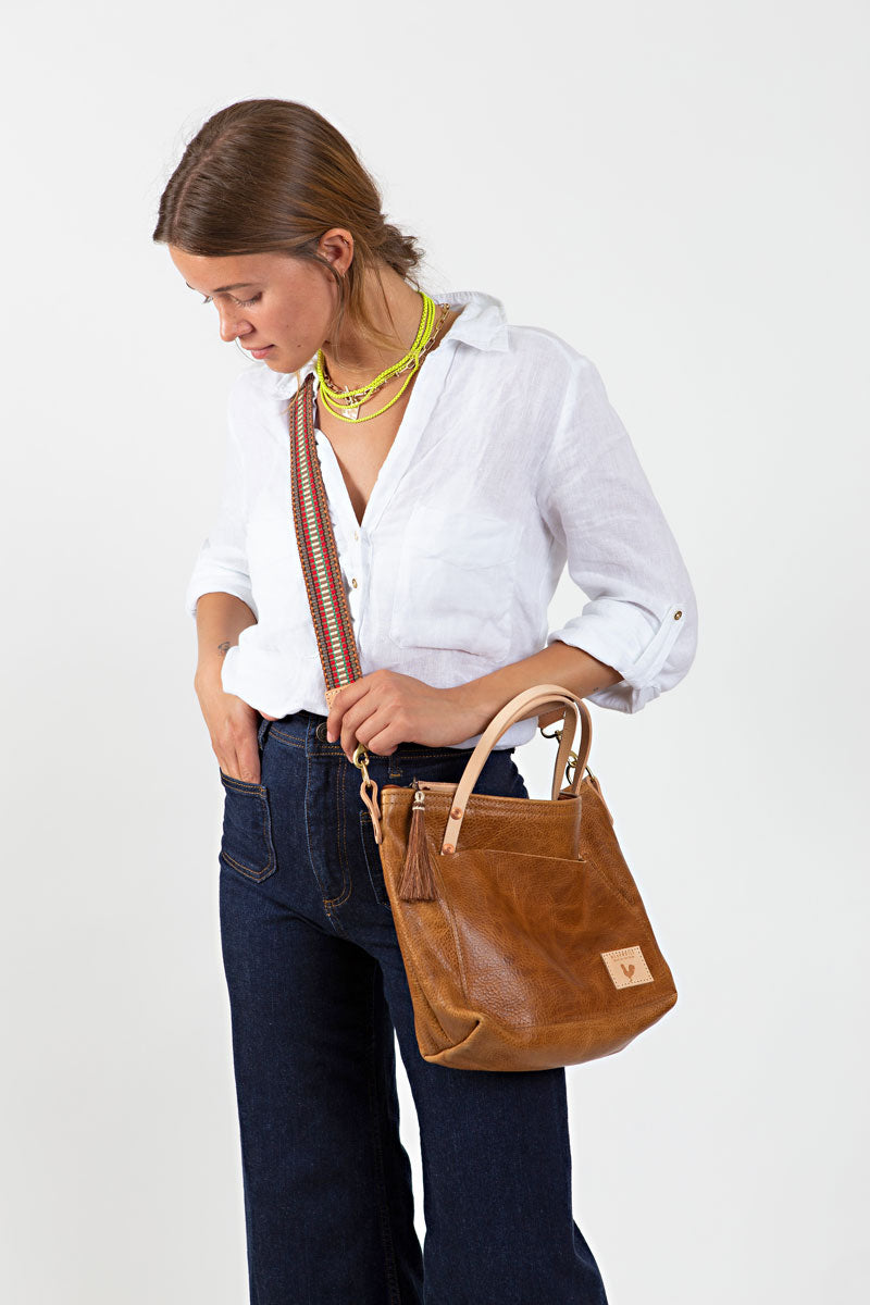 Woman holding camel leather small tote