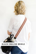 Girl wearing the Cranberry Italian Webbing Crossbody Strap with a small Black leather bag with the text 