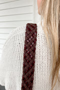 Girl wearing a dark brown woven webbing crossbody strap