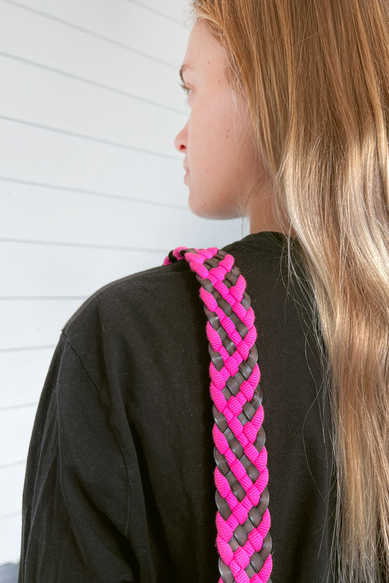 Girl modeling bright pink woven crossbody strap 